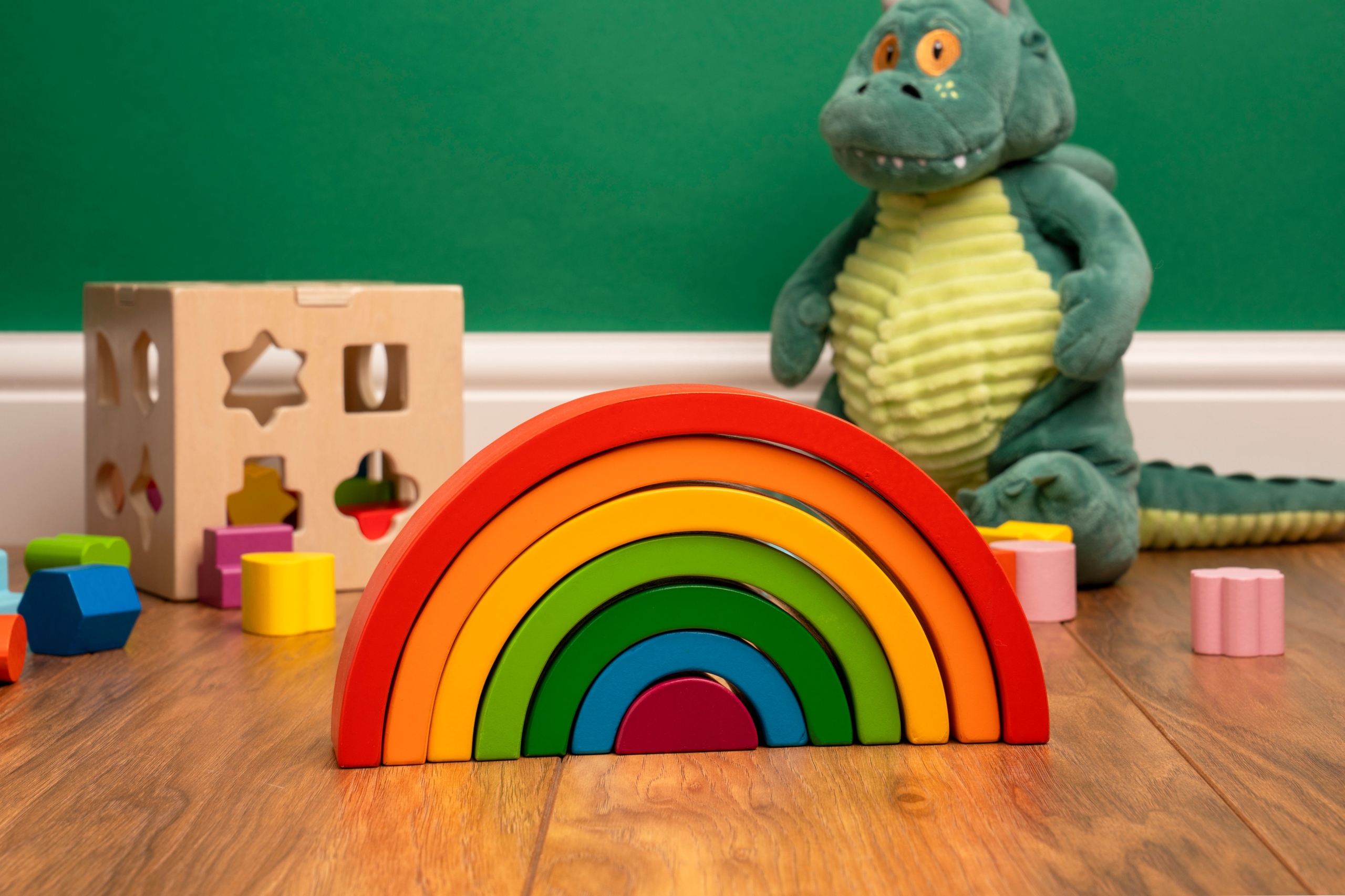 https://www.pexels.com/photo/colorful-wooden-rainbow-and-dinosaur-toy-in-playroom-38695466/